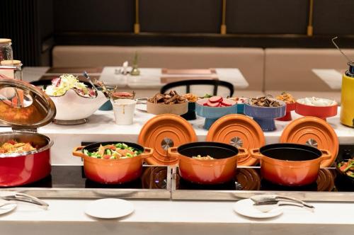 a buffet with different types of food on a table at Elegant International Hotel Shanghai - Bund Sichuan Road North Metro Station Branch in Shanghai