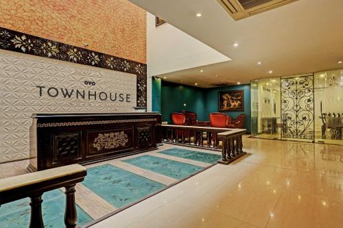 a room with a swimming pool in front of a showroom at Super Townhouse The Royce New Friends Colony in New Delhi