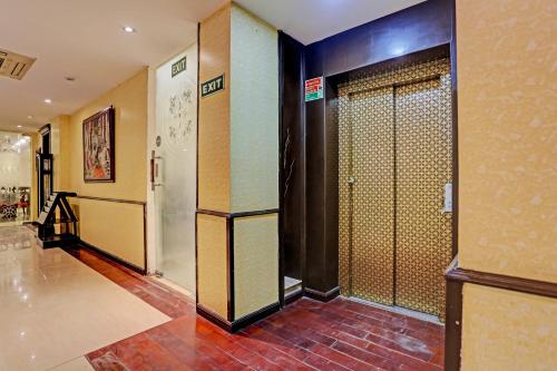 a hallway with a door in a building at Super Townhouse The Royce New Friends Colony in New Delhi