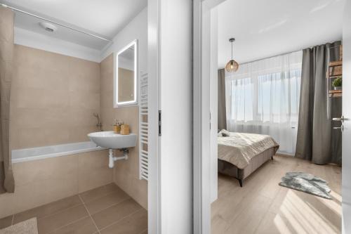a bathroom with a sink and a bed at Sunny, Brand New, Luxury Apartment in Bratislava