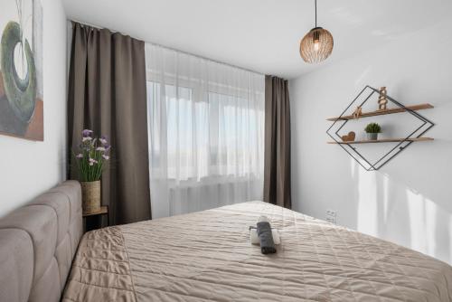 a bedroom with a bed and a window at Sunny, Brand New, Luxury Apartment in Bratislava