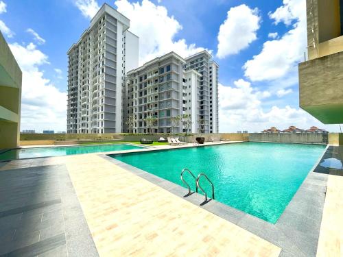 a swimming pool with two tall buildings in the background at Paradigm Residence Johor Bahru in Johor Bahru