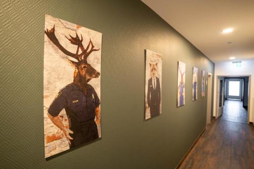 a hallway with a painting of a deer on the wall at SKR Design in Garbsen