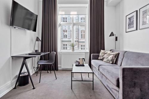 a living room with a couch and a table at Best Western Hotel Hebron in Copenhagen