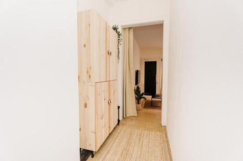a hallway with a sliding barn door in a apartment at City-Apartment Kreuzviertel-Lädchen-60 qm in Münster