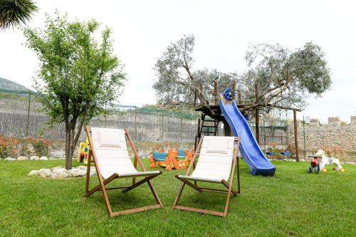 two chairs and a slide in a playground at RUSTICO ALLE MURA Love & Bike in Toirano