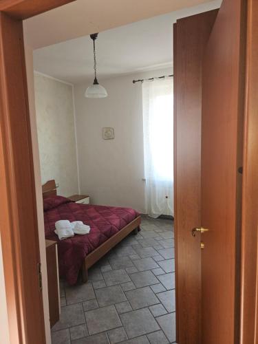 a bedroom with a bed with a red blanket at appartamento palombina vista mare in Ancona