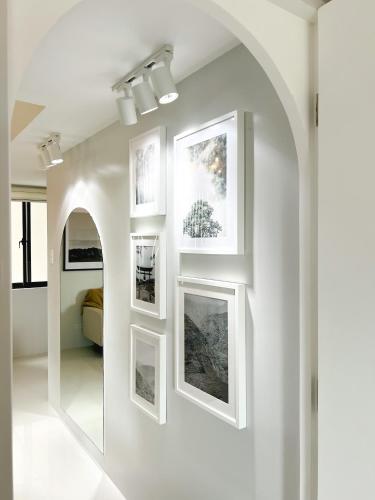 a hallway with framed pictures on a wall at Mi Casa Baguio in Baguio