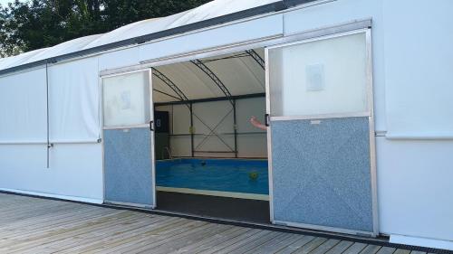 a large building with a pool inside of it at Cosy Chalet, Seasonal Pool & Play Park Llansteffan in Llangain