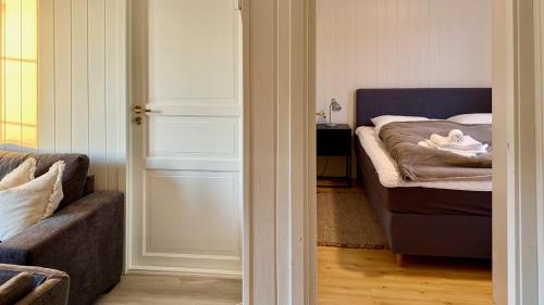 a living room with a bed and a couch at Ballstad Seaside View Lofoten in Ballstad