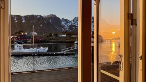 a view of a marina with a boat in the water at Ballstad Seaside View Lofoten in Ballstad