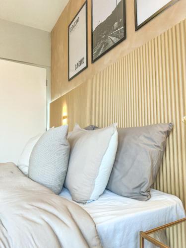 a bed with white pillows on top of it at Mi Casa Baguio in Baguio
