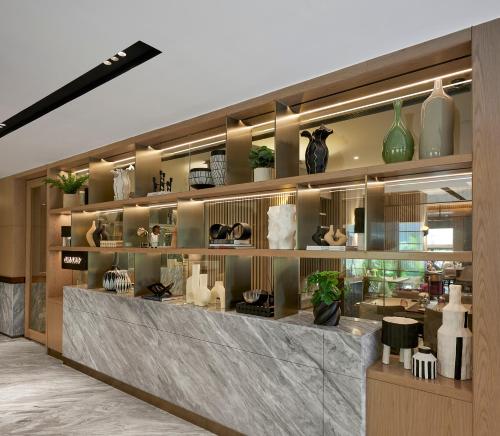 a store with vases and vases on shelves at Astoria Hotel in Mumbai