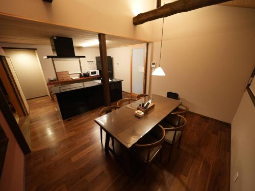 a living room with a wooden table and chairs at Enishiya Izumo in Taisha