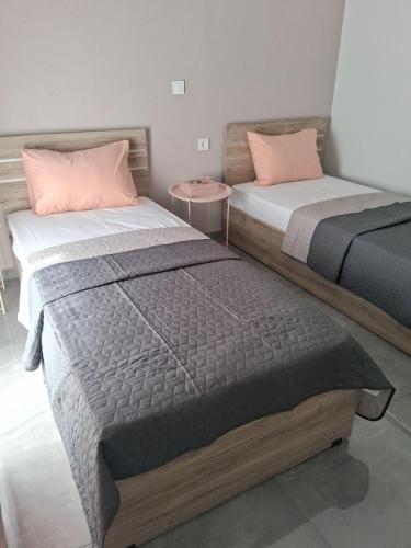 two beds sitting next to each other in a room at Melissan Escape in Mélissa