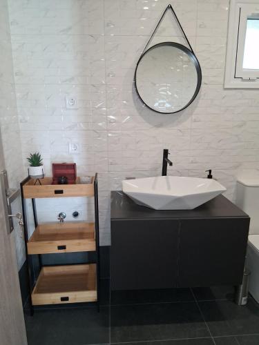 a bathroom with a sink and a mirror at Melissan Escape in Mélissa