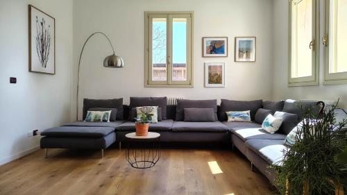 a living room with a blue couch in a room at B&B Monte Adone in Santa Cecilia