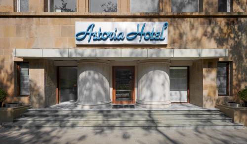 a building with a sign on the front of it at Astoria Hotel in Mumbai