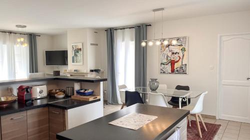 a kitchen and dining room with a table and chairs at Maison Provençale - Piscine & Terrain de Pétanque in Grillon