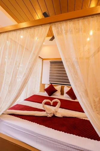 a bedroom with a bed with a canopy at sky blue villa in Vythiri