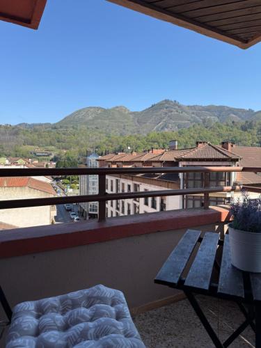a balcony with a table and a view of the mountains at Pension Reconquista in Cangas de Onís