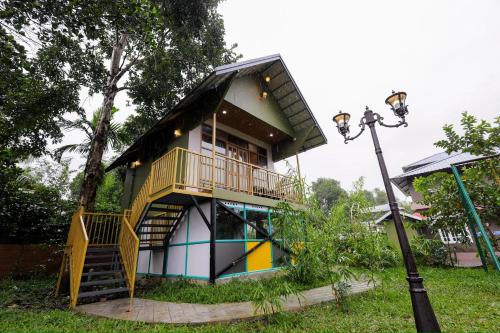a house with a staircase leading up to it at sky blue villa in Vythiri