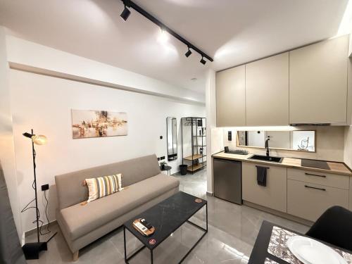 a living room with a couch and a kitchen at Karma - Luxury Living in Katerini