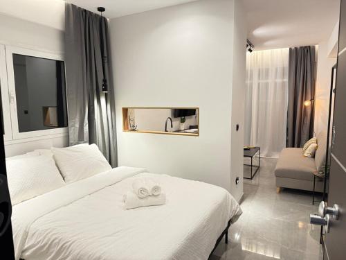 a hotel room with a bed with two towels on it at Karma - Luxury Living in Katerini