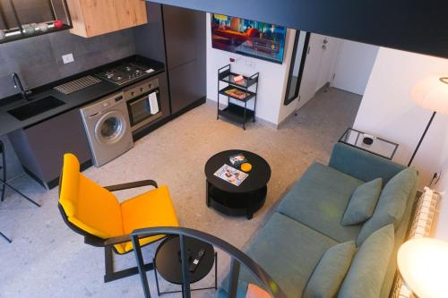 an overhead view of a living room with a couch and a kitchen at High-End Loft in Gemmayze in Beirut