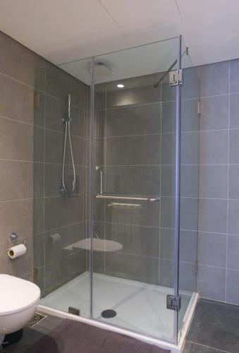 a shower with a glass door in a bathroom at High-End Loft in Gemmayze in Beirut