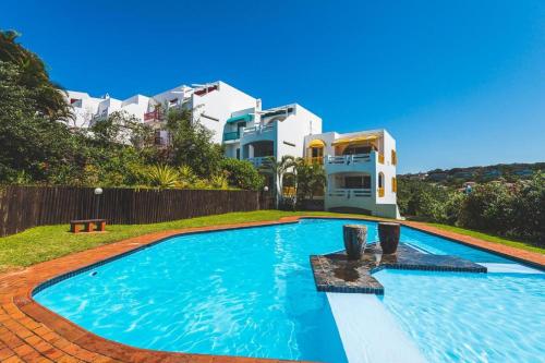 a large swimming pool in front of a house at Easy Breezy at 18 Thira Santorini in Ballito