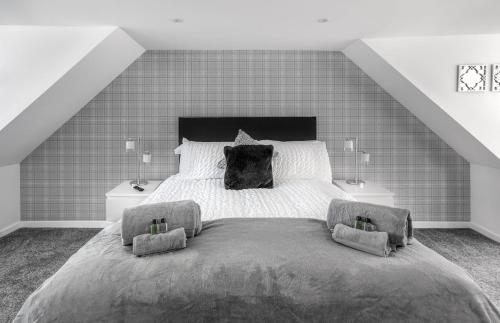 a bedroom with a large bed with two night stands at Castle Street Apartments - Luxury Kilchattan Apartment in Rothesay