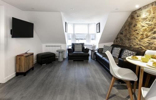 a living room with a couch and chairs and a table at Castle Street Apartments - Luxury Kilchattan Apartment in Rothesay