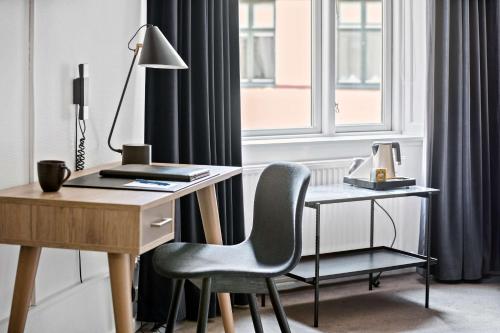 a desk and a chair next to a window at Best Western Hotel Hebron in Copenhagen