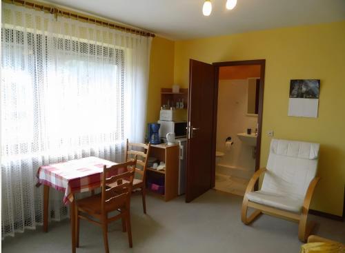 a room with a table and chairs and a bathroom at Apartment Neuenrade in Neuenrade