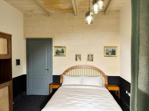 Una cama o camas en una habitación de Il Bekka Suites