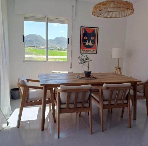 a dining room with a wooden table and chairs at Apartamento en Playa Honda - La Manga in Cartagena