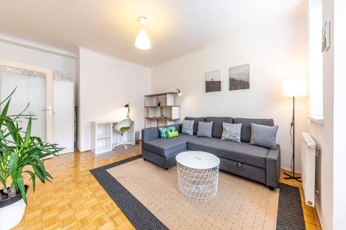 a living room with a couch and a table at YOUNG VIENNA by JR City Apartments in Vienna
