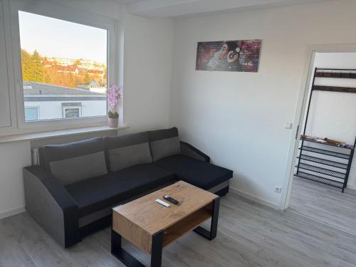 a living room with a couch and a coffee table at Ferienwohnung VS in Villingen-Schwenningen