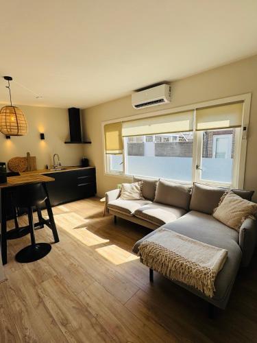 a living room with a couch and a table at Willem's Beachhouse in Noordwijk