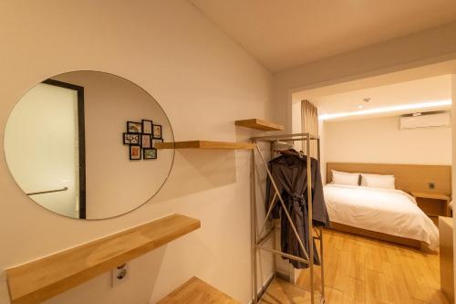 a bedroom with a mirror and a bed at H Avenue Chuncheon in Chuncheon