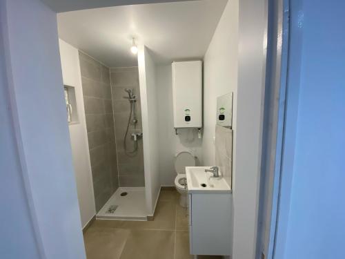 a bathroom with a shower and a toilet and a sink at G-Logement-Francilien Villa Parc des expositions Villepinte, Bourget, Astérix , Paris in Goussainville