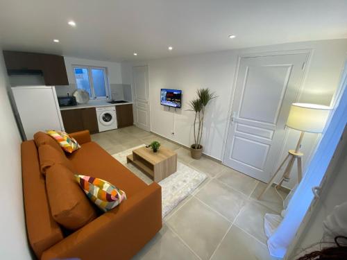 a living room with a couch and a table at G-Logement-Francilien Villa Parc des expositions Villepinte, Bourget, Astérix , Paris in Goussainville
