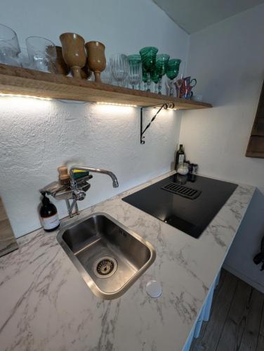 a kitchen with a sink and a counter top at Drängstugan in Kolbäck