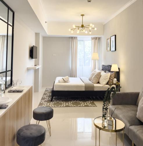 a living room with a bed and a couch at Mi Casa Baguio in Baguio