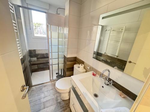 a bathroom with a sink and a toilet and a mirror at Las Terrazas de Manzanera con zona exterior by apartamentos Logrono in Logroño