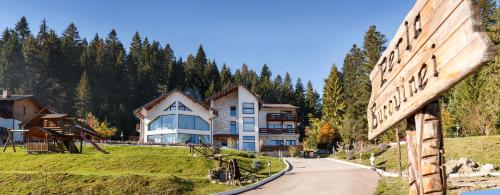 a large house on a hill with a road at Pension Perla Bucovinei in Voronet