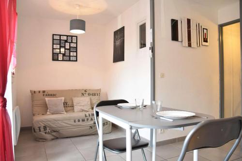 un salon avec une table et un canapé dans l'établissement Appartement 2 pièces - Gruissan GN170-115, à Gruissan