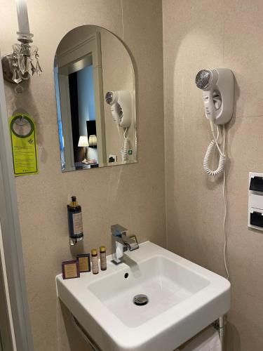 a bathroom with a white sink and a mirror at REZYDENCJA BOHEMA in Szczawno-Zdrój