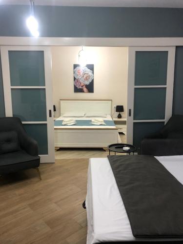 a bedroom with a bed and a couch and a chair at the best apartment in Kutaisi